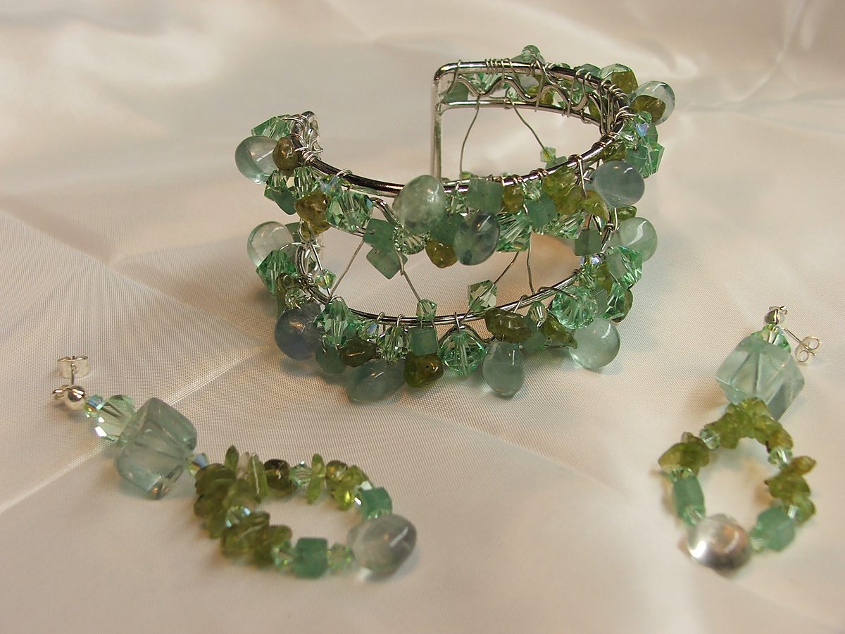 Wire-wrapped cuff and earrings in pale green crystal and gemstone